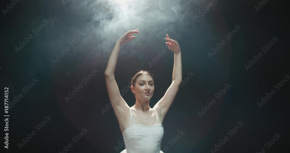 graceful ballerina during the training in the Studio. Smoke, fog, slow motion ballerina in a white tutu, whirling in the dance graceful ballerina during the training in the Studio. Smoke, fog, slow motion ballerina in a white tutu, whirling in the dance