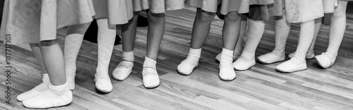children's legs in ballet slippers