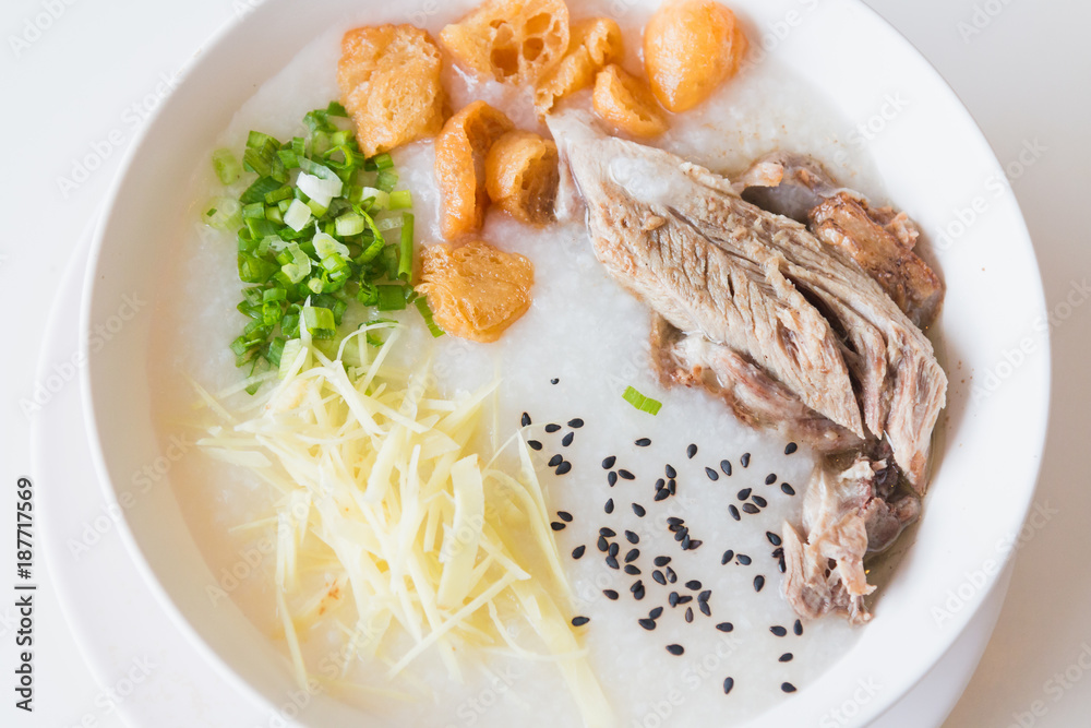 Pork porridge with ginger and coriander in bowl. Pork porridge with ginger and coriander in bowl.