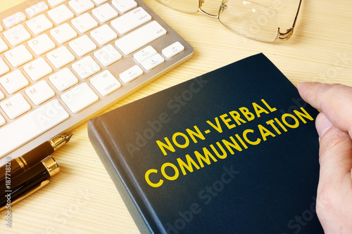 Book about NVC Non-verbal communication on a table. photo