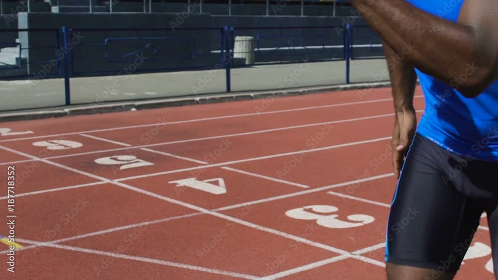 Hispanic athlete passing baton to his teammate, relay run, track and field