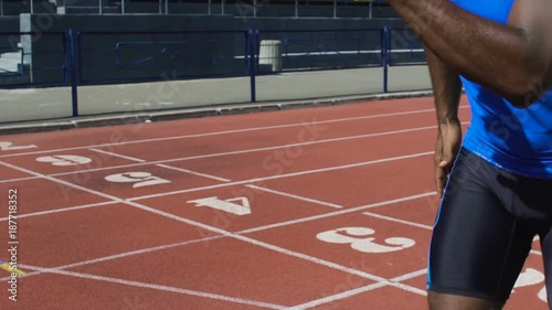 Hispanic athlete passing baton to his teammate, relay run, track and field