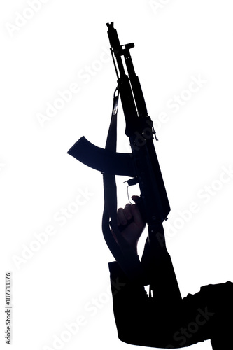 Silhouette of person's hand holding rifle against white background