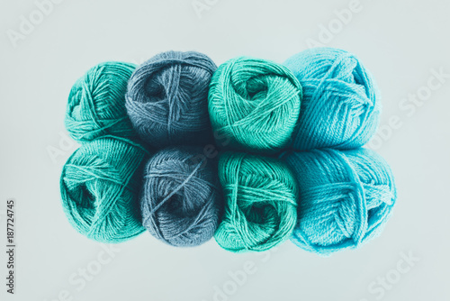 top view of blue and green knitting yarn balls, isolated on white