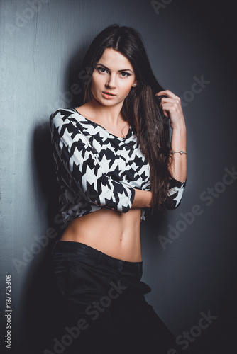 Beautiful, young and emotional girl in studio, on a dark background