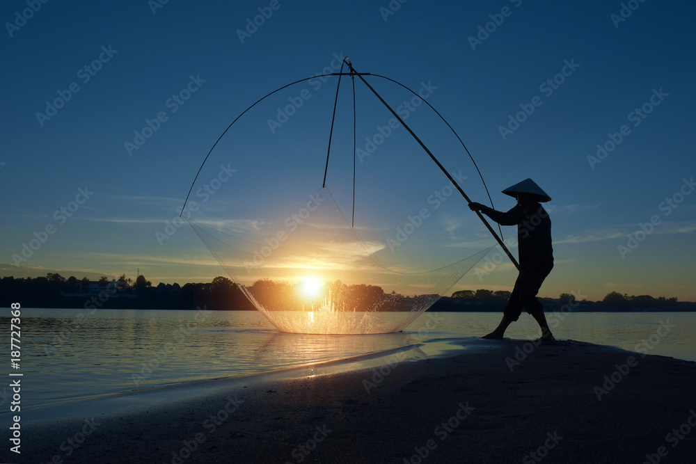 Fishermen using fishing nets.Silhouette fisherman on boat ,fishingman net, fishingman on boat, fisherman silhouette,fisherman boat, fishing with nets in the morning