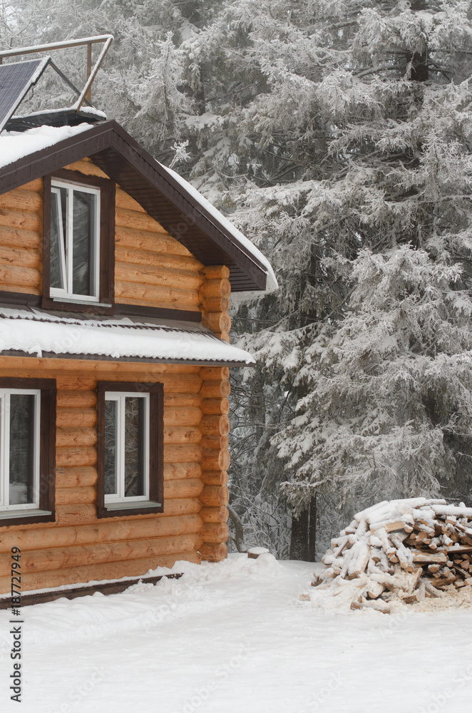 wooden house in a snow-covered forest wooden house in a snow-covered forest