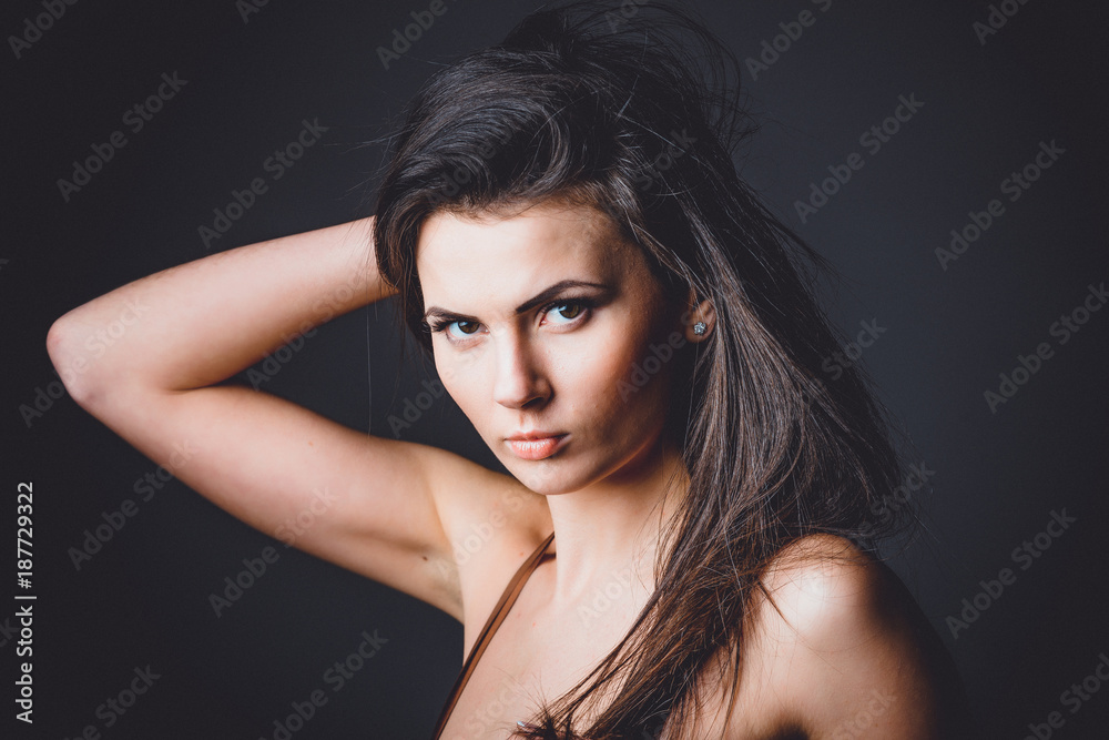 Beautiful, young and emotional girl in studio, on a dark background Beautiful, young and emotional girl in studio, on a dark background