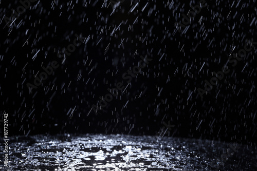 Dark background shot of rain falling