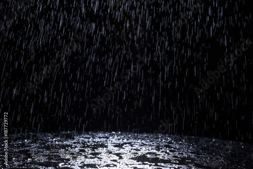 Dark background shot of rain falling