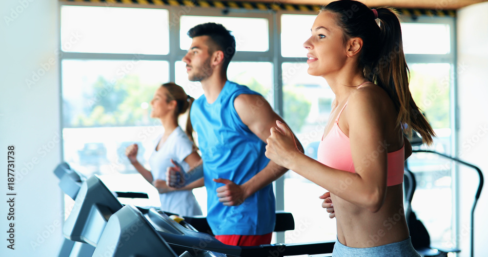 Group of friends exercising on treadmill machine