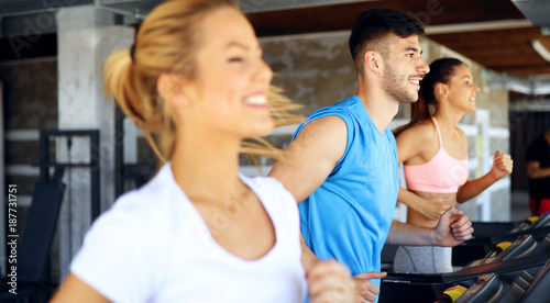 Fototapeta Naklejka Na Ścianę i Meble -  Picture of people running on treadmill in gym