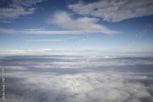 Fototapeta Naklejka Na Ścianę i Meble -  flying high in a blue sky with white clouds and sun shine