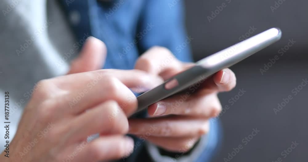 Woman using smart phone at home