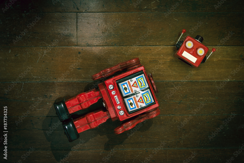Obraz premium retro red robot has lost his head on a old wooden floor