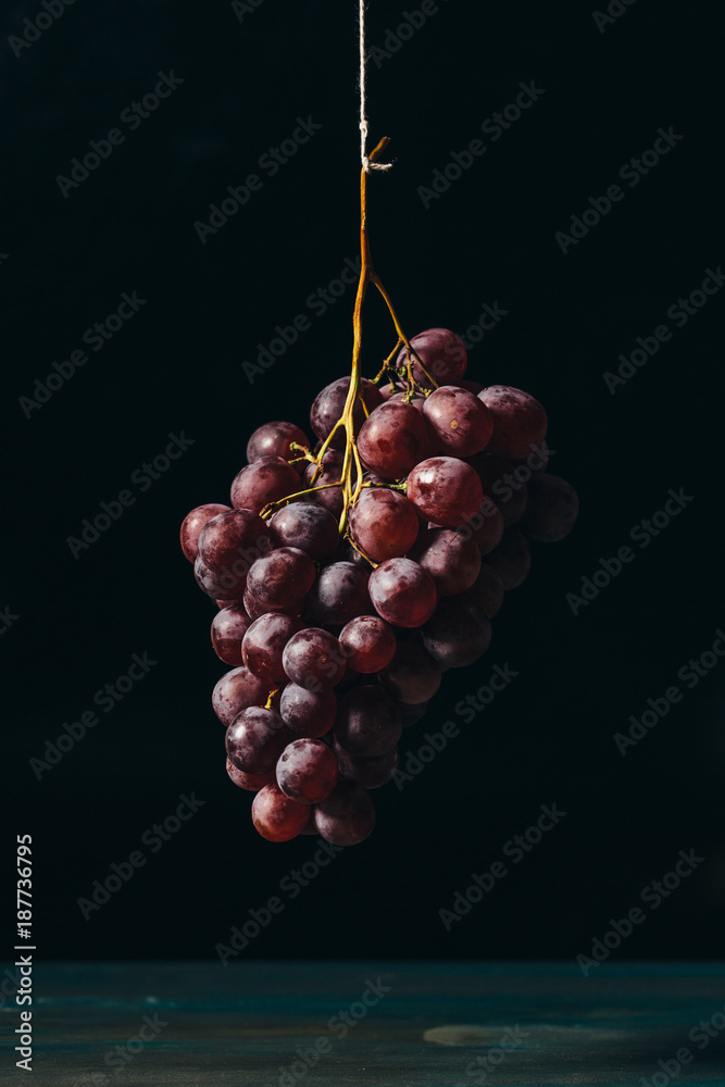 Hanging fresh red grapes, vintage style.