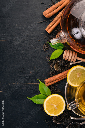 Black and green tea with lemon, honey, cinnamon and ginger. Hot drink Top view. Copy space.