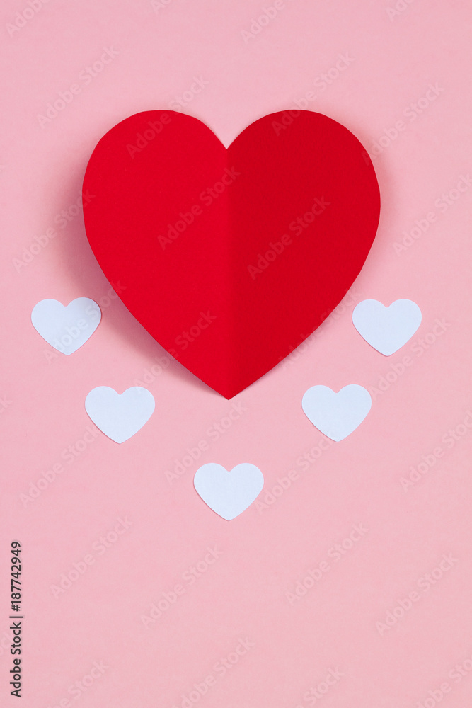Red paper heart on the pink background. Valentine's or Wedding's day postcard concept.