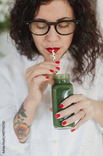 Young woman drinking smoothie