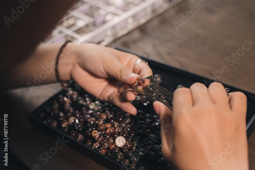 Jeweler making of handmade stone beads jewellery.
