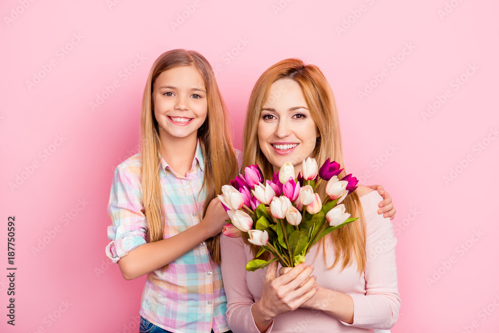 Pretty, lovely, nice, mum and daughter with beaming smiles celebrating women's day, standing over pink background, holding colorful tulips, looking at camera, leisure, happiness, fun, trust Pretty, lovely, nice, mum and daughter with beaming smiles celebrating women's day, standing over pink background, holding colorful tulips, looking at camera, leisure, happiness, fun, trust
