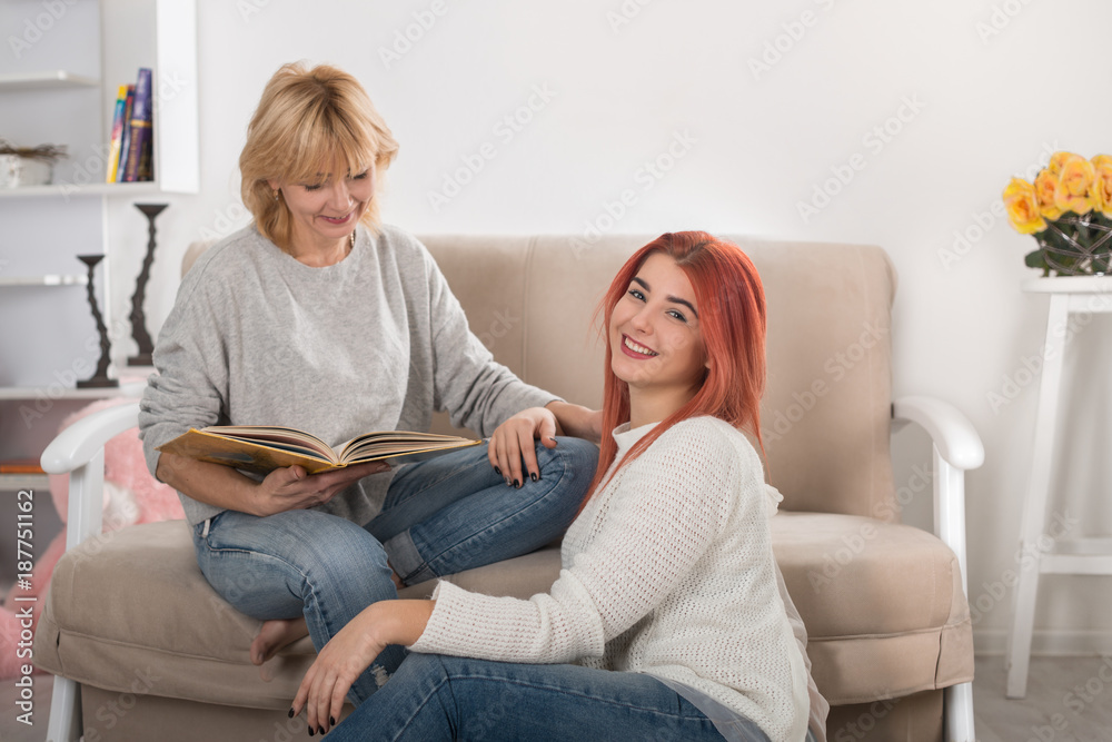 Mother with love and heat reads the book by the adult daughter as in the childhood.