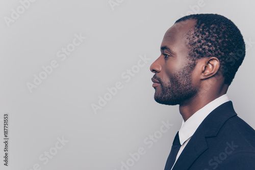 Side profile view portrait of smart experienced qualified clever strict head on big company clothed in black jacket and white shirt looking aside isolated on gray background copyspace photo