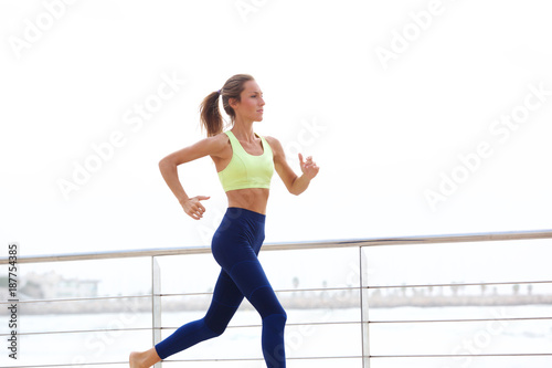 Fototapeta Naklejka Na Ścianę i Meble -  healthy sports woman running by the sea
