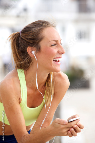 young woman listening to music with MP3 player and earphones