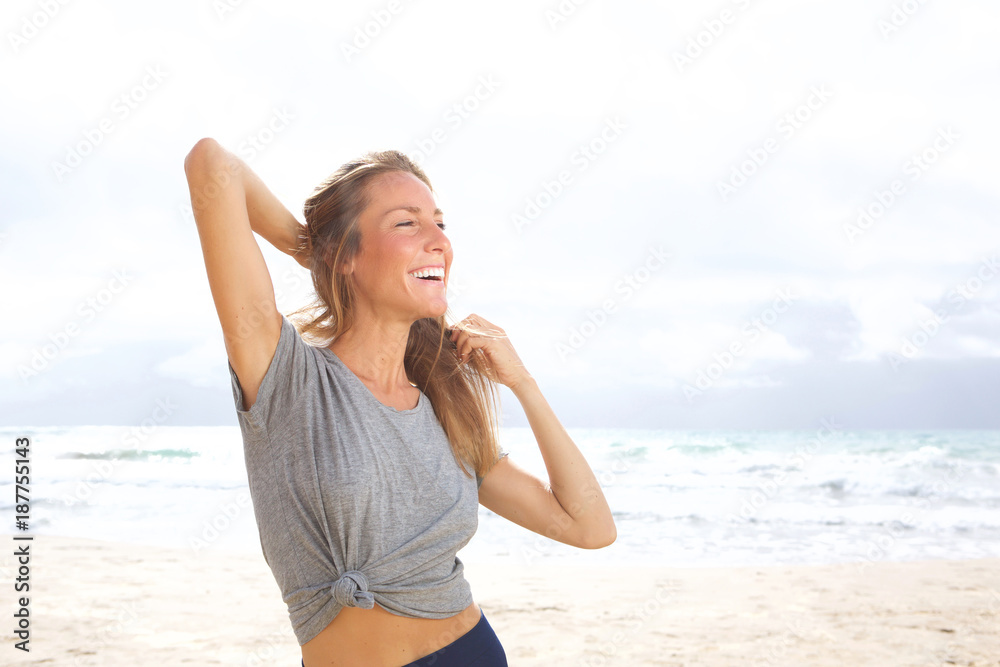beautiful young woman laughing at the beach beautiful young woman laughing at the beach