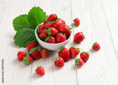 Healthy strawberries in bowl on wooden table. Close up, high resolution product. Harvest Concept