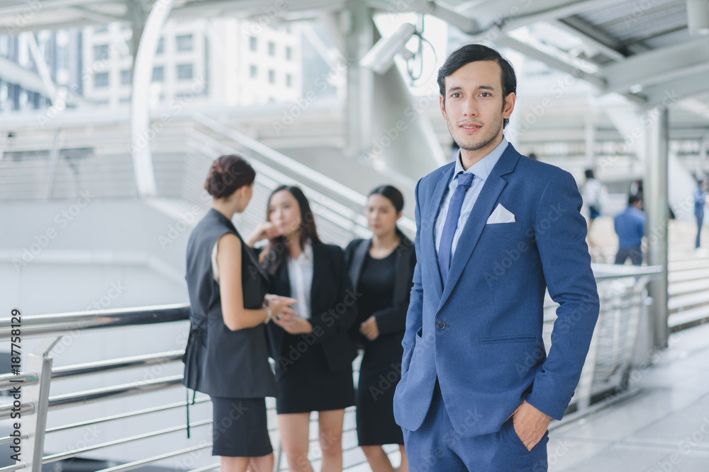 Smart businessman in full suit standing outdoors in cityscape background Smart businessman in full suit standing outdoors in cityscape background