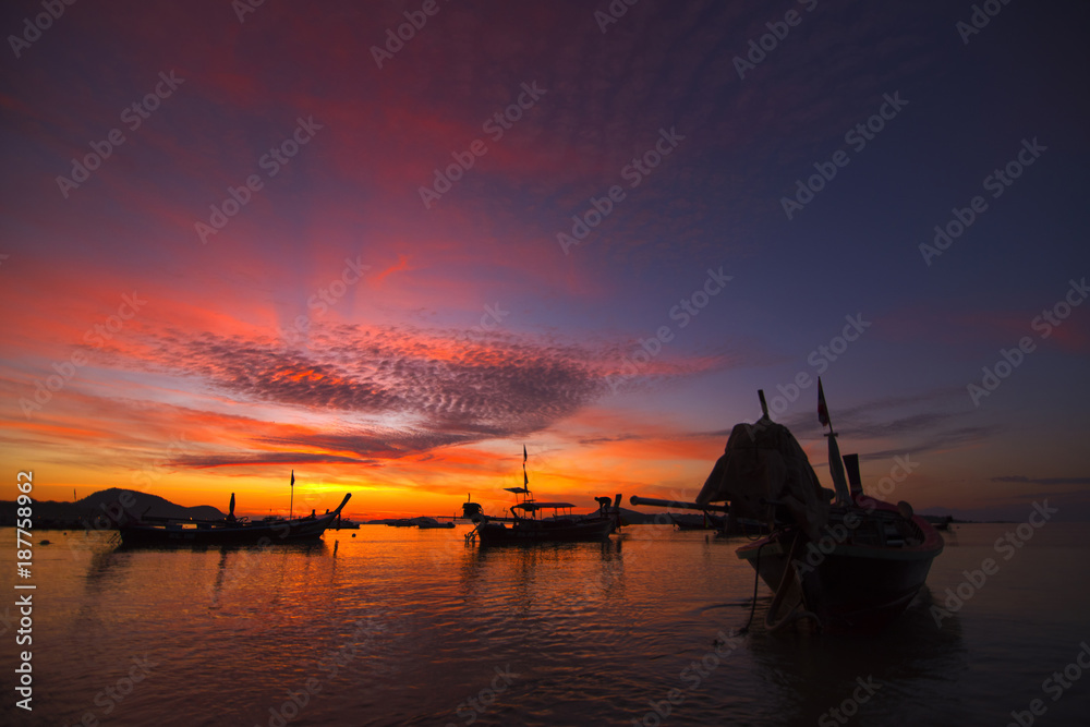 twilight beautiful sky at rawai beach in morning with Andaman boat.
