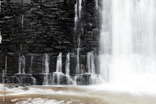 Water Cascading over and through a stone wall.