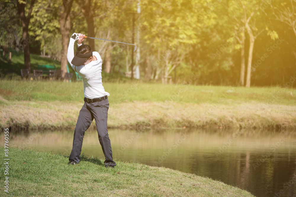 Asian man golf player swinging driver golf club on golf course. Asian man golf player swinging driver golf club on golf course.