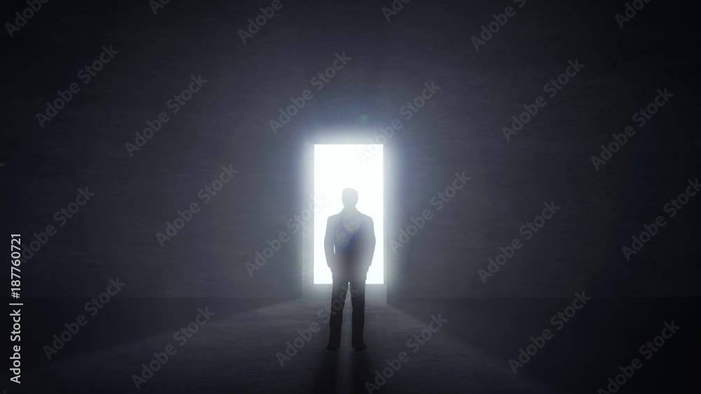 Man standing at opening glowing door in darkness, light rays coming trough. Challenge concept.