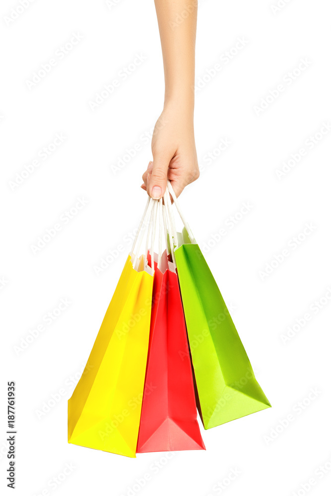 Female hand holding shopping bags, isolated on white background