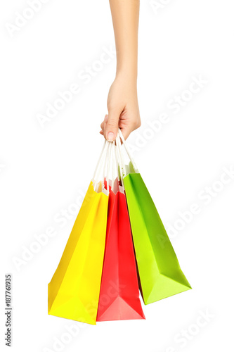 Female hand holding shopping bags, isolated on white background