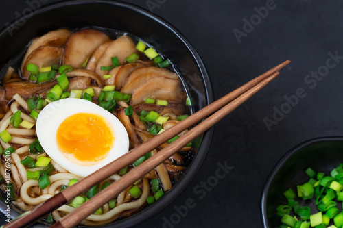 Ramen soup with mushrooms, horizontal, black background