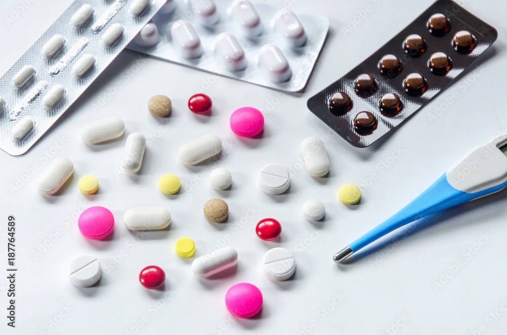 Top view of the pills on the white background, Pack of tablet drug and capsule pills on the floor, Pile of the drug and pills on the white background. Top view of the pills on the white background, Pack of tablet drug and capsule pills on the floor, Pile of the drug and pills on the white background.