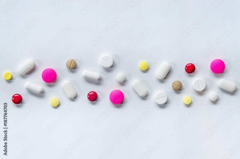 Top view of the pills on the white background, The drug and capsule pills on the floor, Pile of the drug and pills on the white background. Top view of the pills on the white background, The drug and capsule pills on the floor, Pile of the drug and pills on the white background.