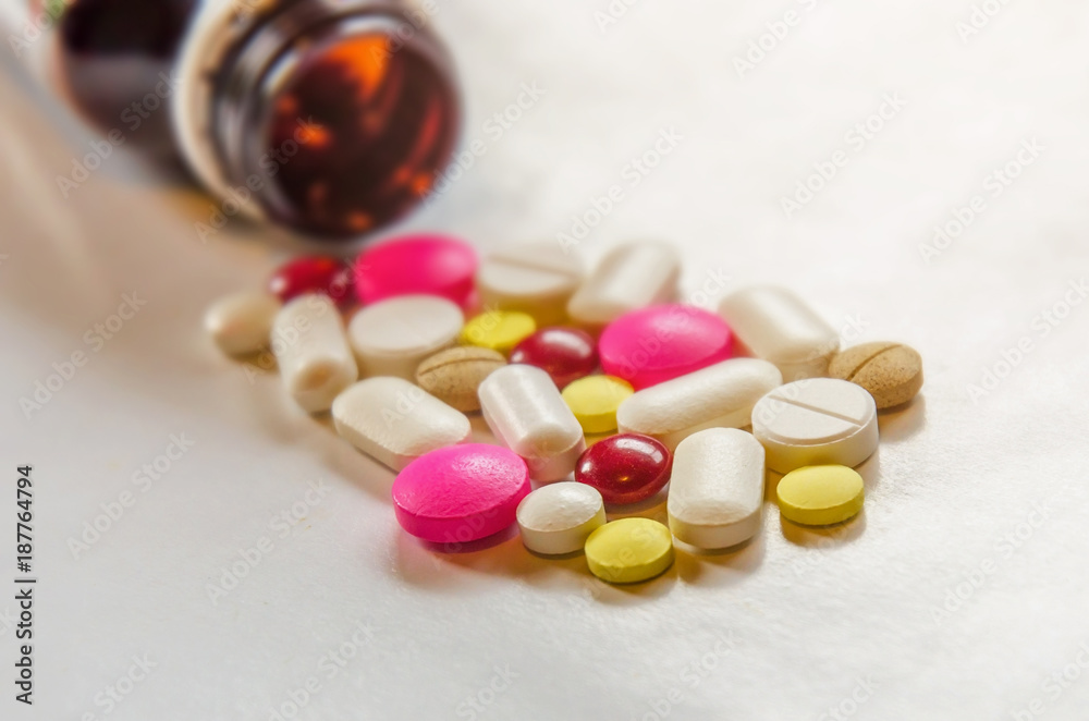 Close-up of the pills on the white background, The drug and capsule pills on the floor, Pile of the drug and pills on the white background. Close-up of the pills on the white background, The drug and capsule pills on the floor, Pile of the drug and pills on the white background.