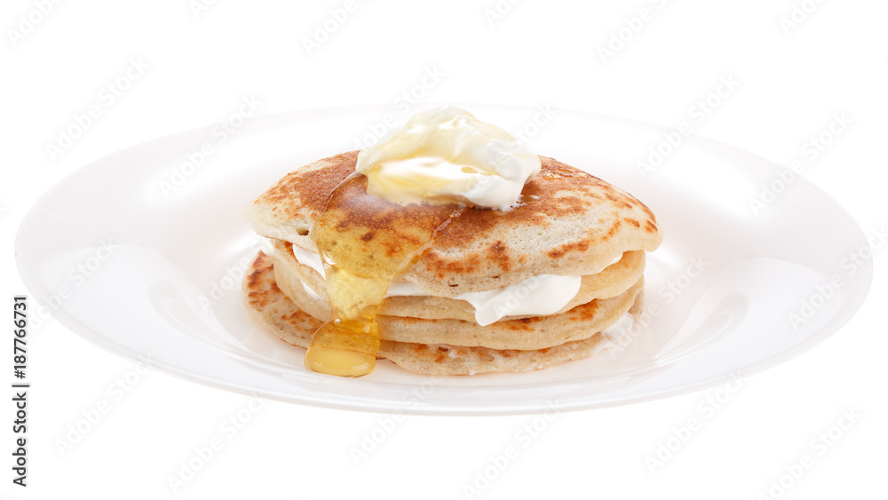 Serving pancakes with sour cream and honey on the plate. Isolated on white background. Serving pancakes with sour cream and honey on the plate. Isolated on white background.