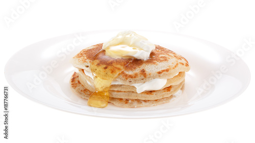 Serving pancakes with sour cream and honey on the plate. Isolated on white background.