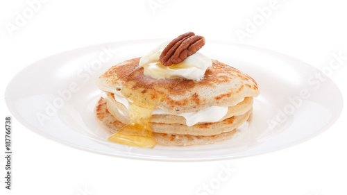 Serving pancakes with sour cream honey and nut on the plate. Isolated on white background.