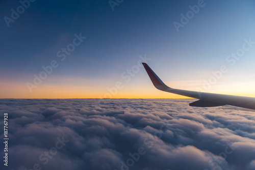 Sky and clouds with airplane wing in morning