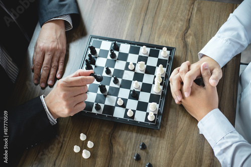 Confident businessman colleagues playing chess game overcome the fear of confrontation to development analysis new strategy plan, leader and teamwork concept for success