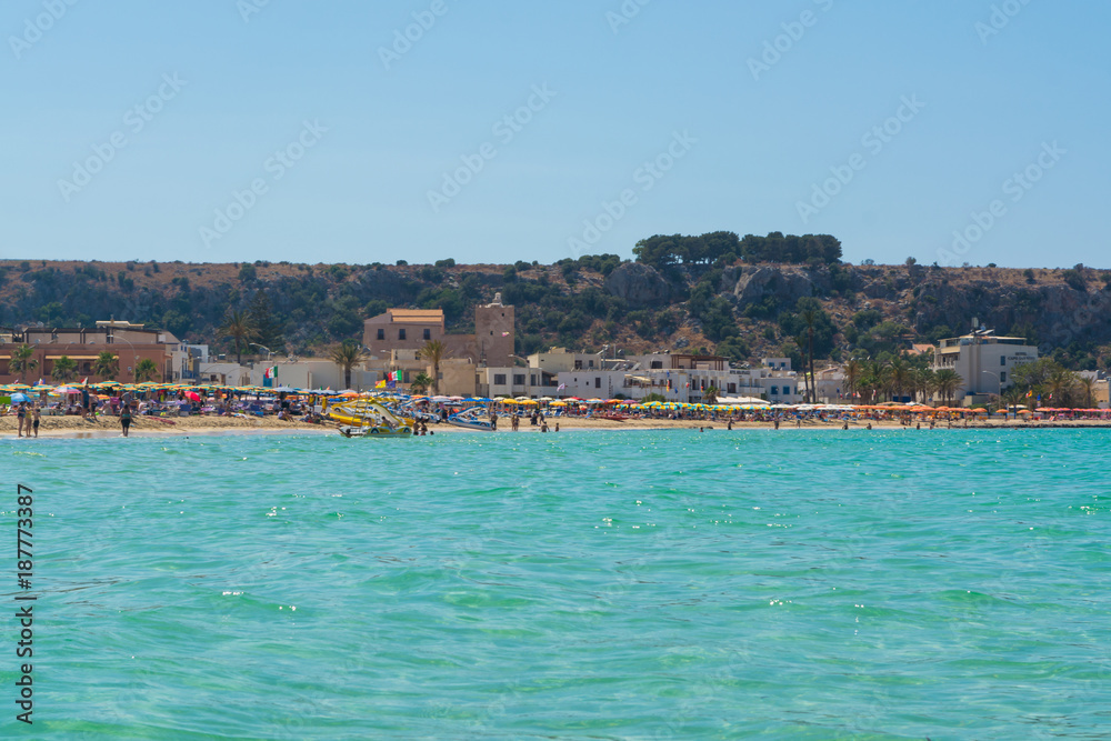 Beautiful white sand beach in San Vito lo Capo, Sicily, Italy with colorful umbrellas