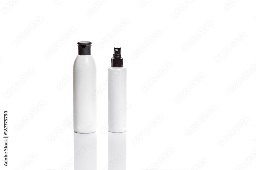 Set of cosmetic products in white containers on light background. Set of cosmetic products in white containers on light background.