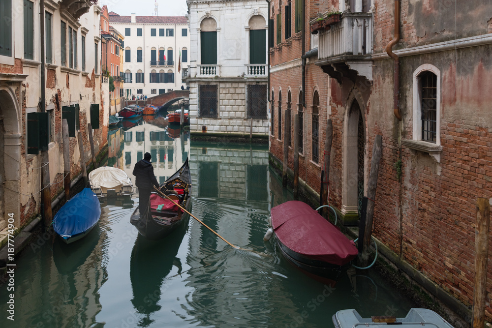 Gondola ride in Venice canal , Italy